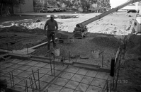Workers performing construction duties during the construction of headquarters addition.