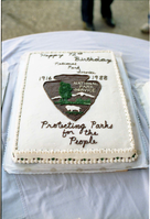 Color Photos of the parks 72nd anniversary celebrations- cake cutting, barbecue, speakers.
