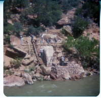 Men building stone abutment for the new Grotto footbridge.