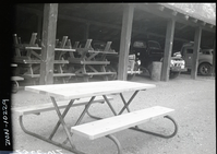 New type (iron and wood) campground picnic tables in utility area.