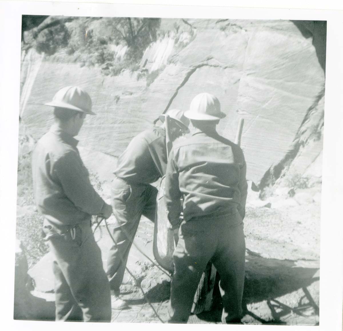 Workers operating construction equipment during the West Rim trail half tunnel maintenance/stabilization.