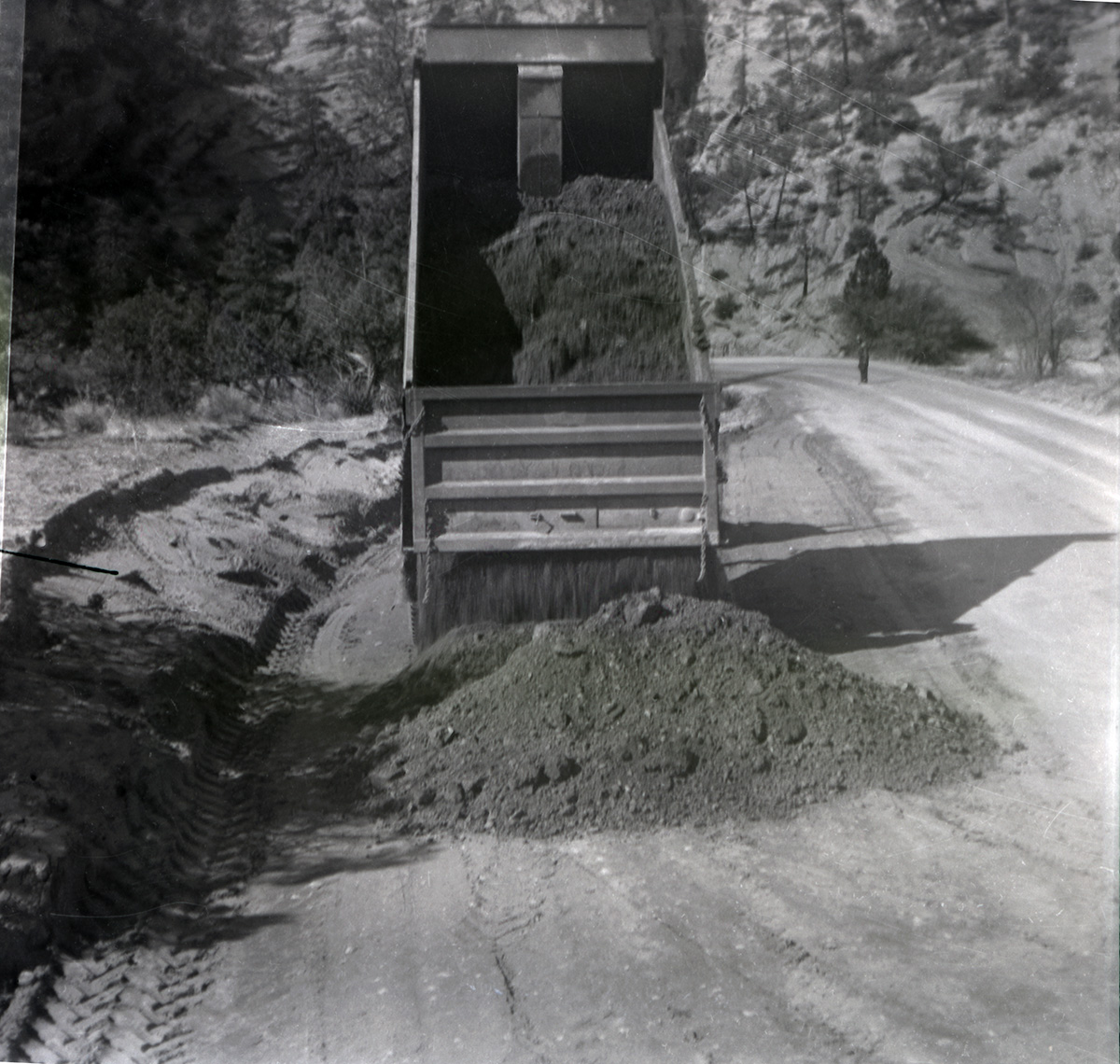 Dump truck dumping dirt during east side road repair and turn out construction.
