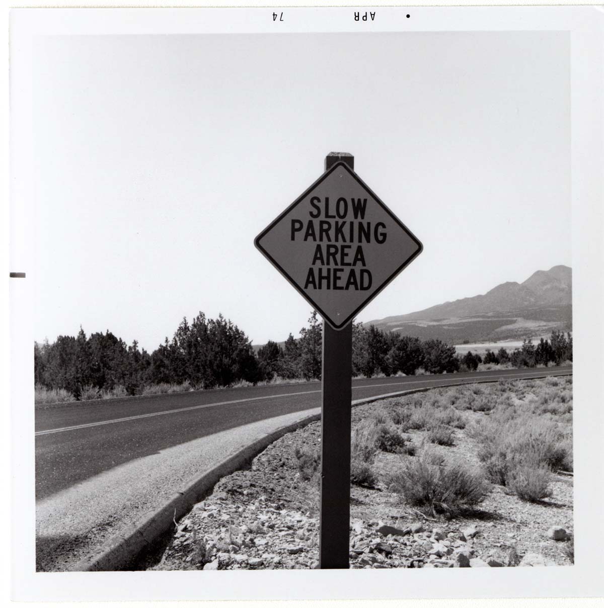 Road sign reading 'Slow Parking Area Ahead' in Kolob Canyon.
