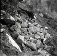 Rip rap reinforcing steep slope from erosion.