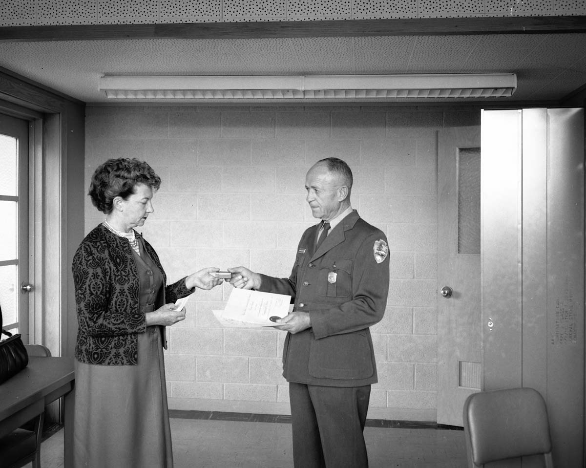 Superintendent Oberhansley presents award of meritorious service to Mrs. Elsa Ruesch at her retirement after 30 years of service.