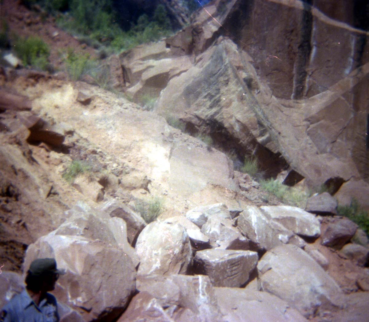 Color Photo of a rock slide along road.