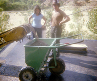 Workers standing by as a roofing cart is filled with roofing material during headquarters/visitor center roofing project.