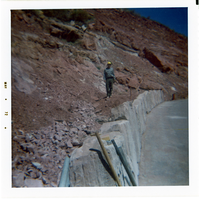 Man helping to construct the slide control wall along Kolob Canyon Road.