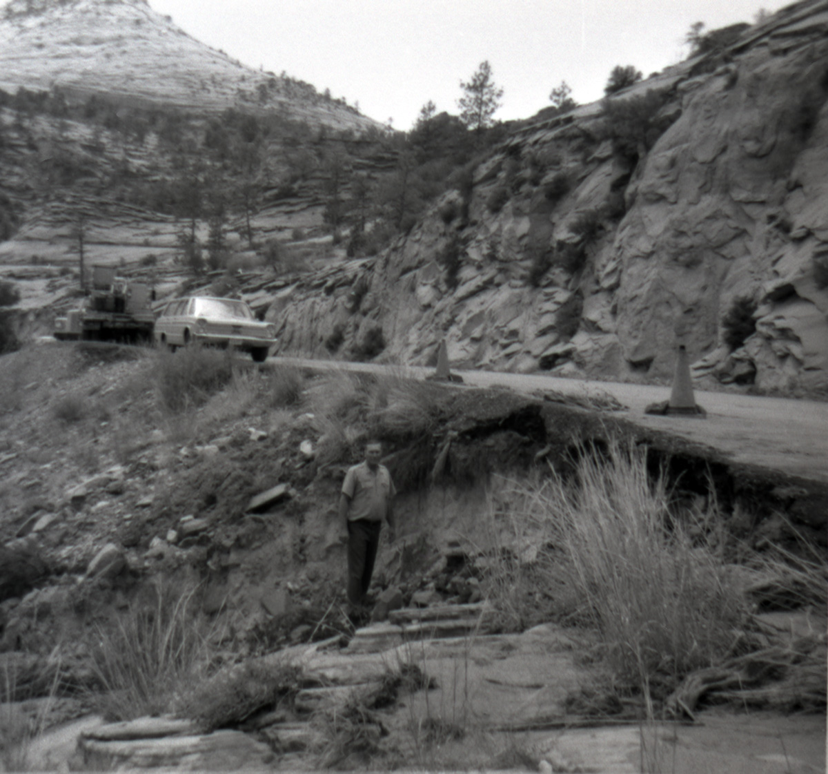 Construction vehicles along side of the road while man surveys area during East side road repair and turn our construction - Road projects 5104 and 5105.