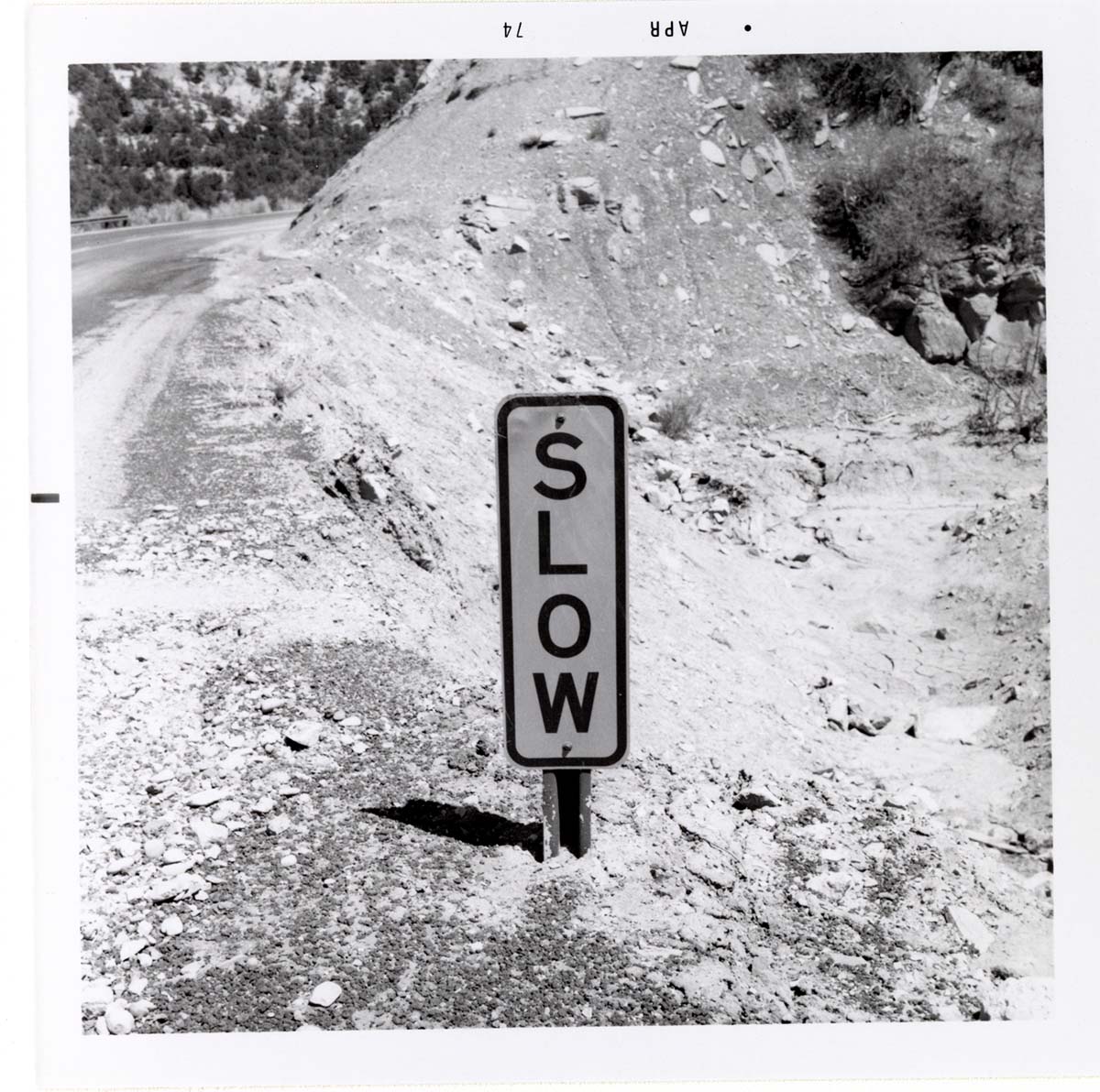 Road sign reading 'SLOW' in Kolob Canyon.
