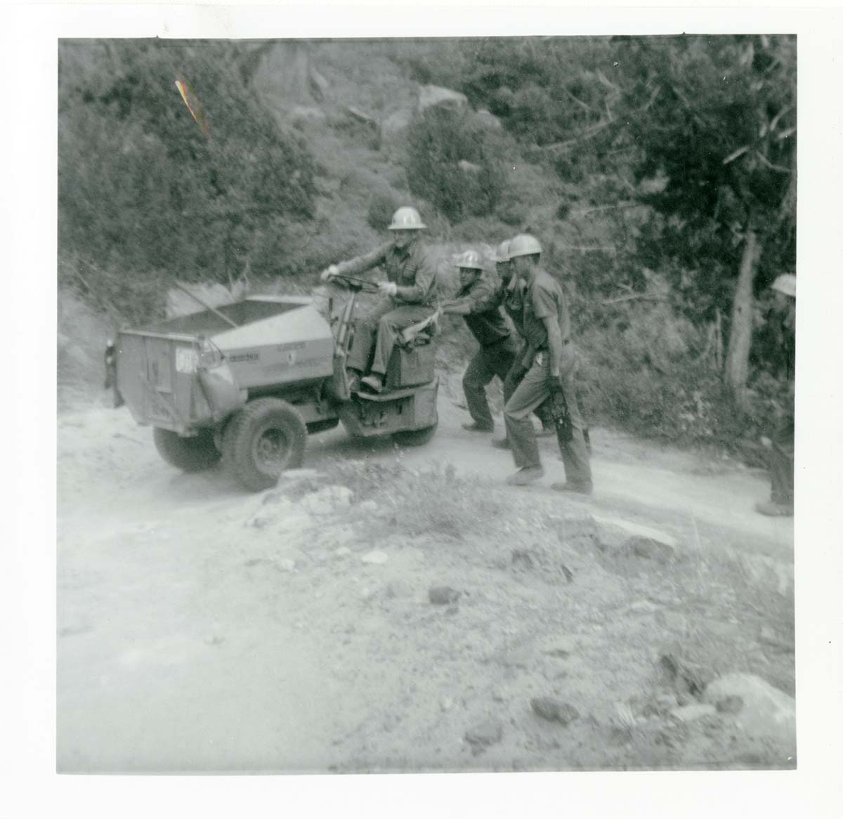 Workers operating construction equipment during the West Rim trail half tunnel maintenance/stabilization.