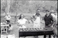 BW Photos of the Crocker/ Nicholson retirement barbeque. Superintendent Harold Grafe in apron at grill with man and woman.