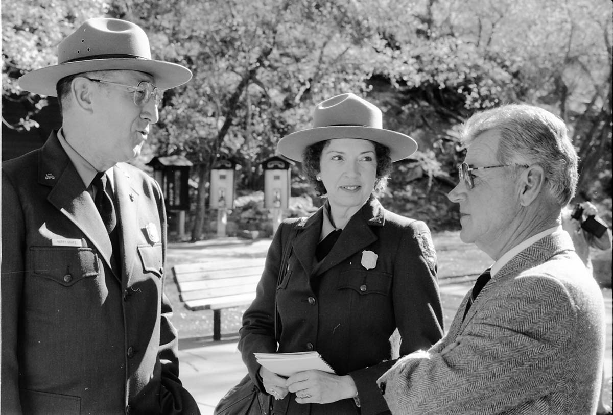 BW Photos of the Zion Lodge Rededication Ceremony. Superintendent Harold (Harry) Grafe speaking with man and woman.