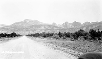 Kolob peaks looking west of Highway 91 (I-15) on road to new harmony toward peaks. Fender in foreground of frame.