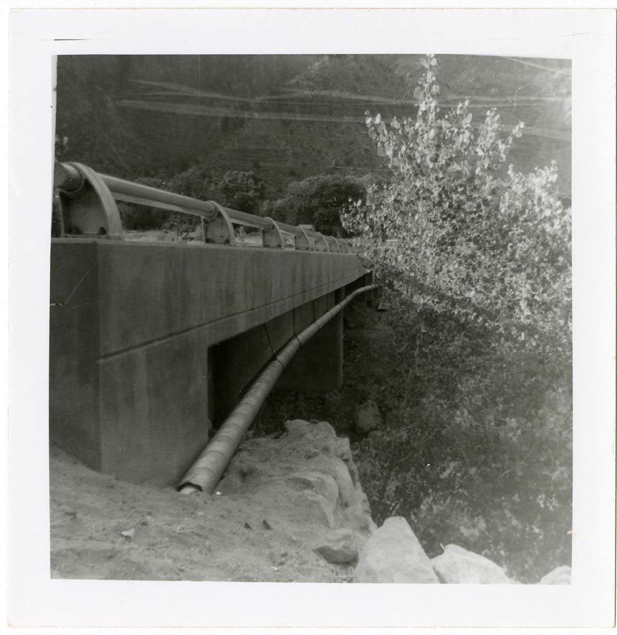 Piping system on underside of bridge during the Watchman housing utility project.