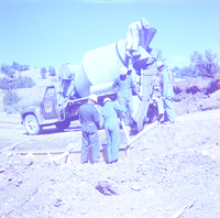 Men pouring cement during road construction and repairs.