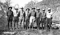 Field portrait of eight Emergency Conservation Work (ECW) personnel, right to left: Floyd Keller, Charles Peyrone, Gordon Croft, Ben Wetherill, Civilian Conservation Corps (CCC) Superintendent Dan Birch, [unknown], Riley, [unknown].