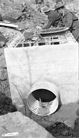 Civilian Conservation Corps (CCC) workers and park laborers constructing a sedimentation box at the Virgin River diversion dam.