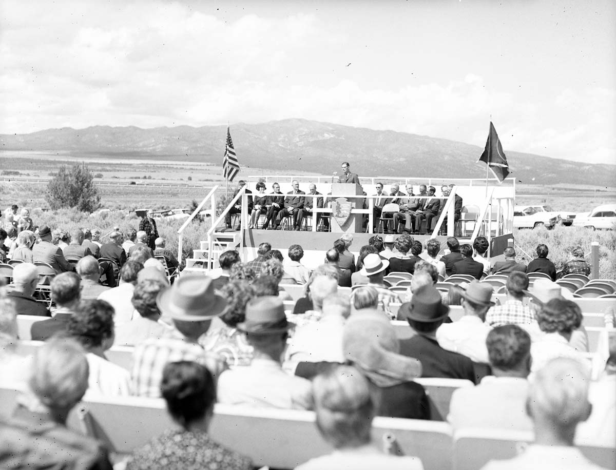 Warren F. Hamilton, Superintendent of Zion National Park, addressing visitors from podium at dedication of Taylor Creek road (Kolob Canyons).