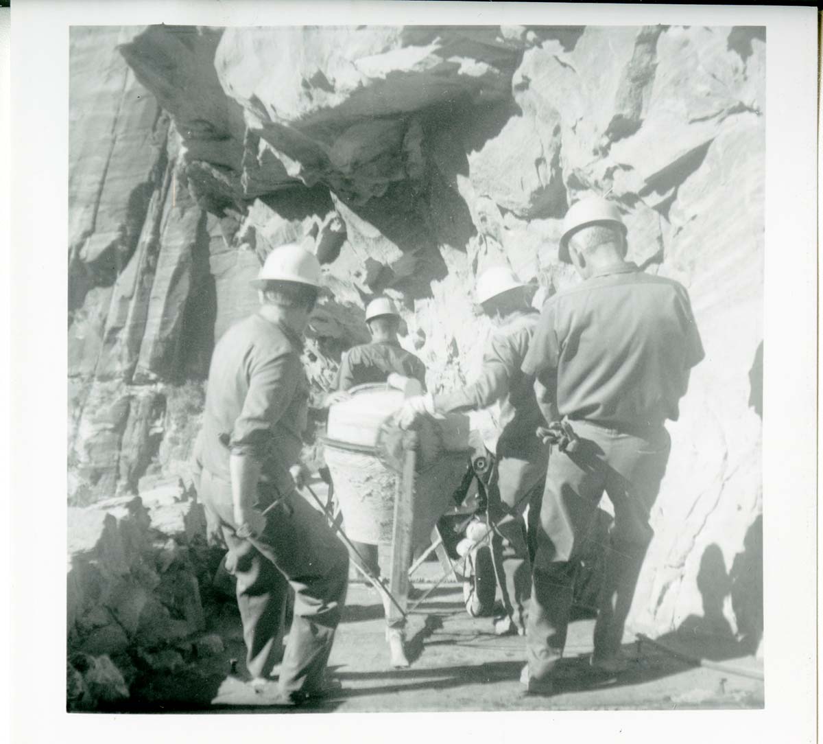 Workers operating construction equipment during the West Rim trail half tunnel maintenance/stabilization.