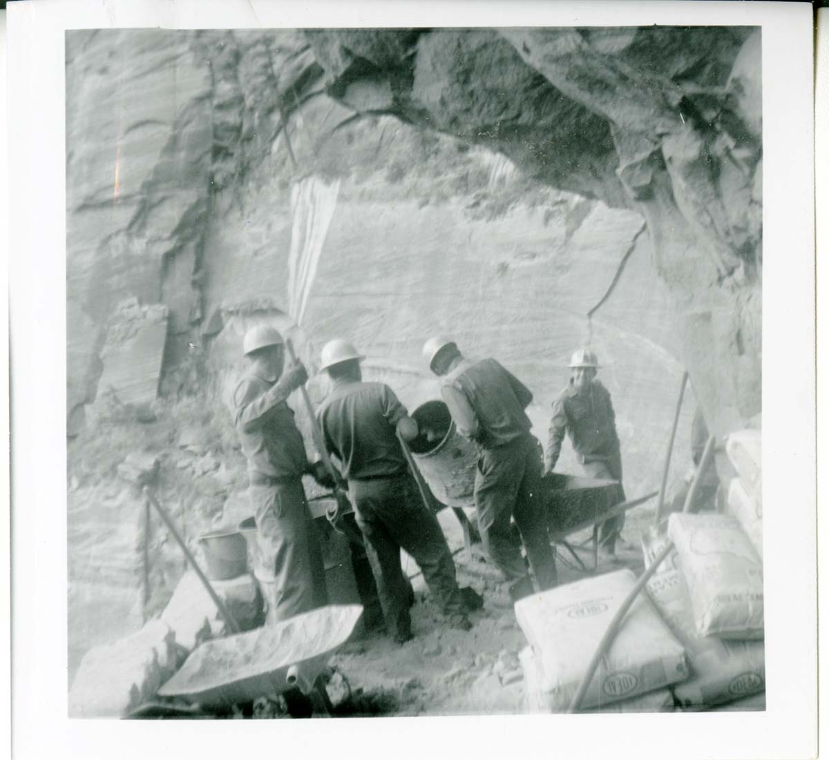Workers operating construction equipment during the West Rim trail half tunnel maintenance/stabilization.