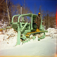 Color Photos of the parks snowplow/ tractor.