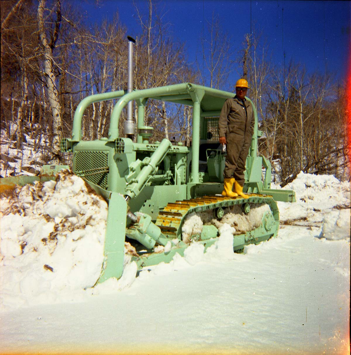 Color Photos of the parks snowplow/ tractor.