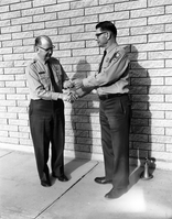 Superintendent Warren F. Hamilton presenting Chief Park Naturalist Carl E. Jepson (right) with Service Award pin for 30 years of service.