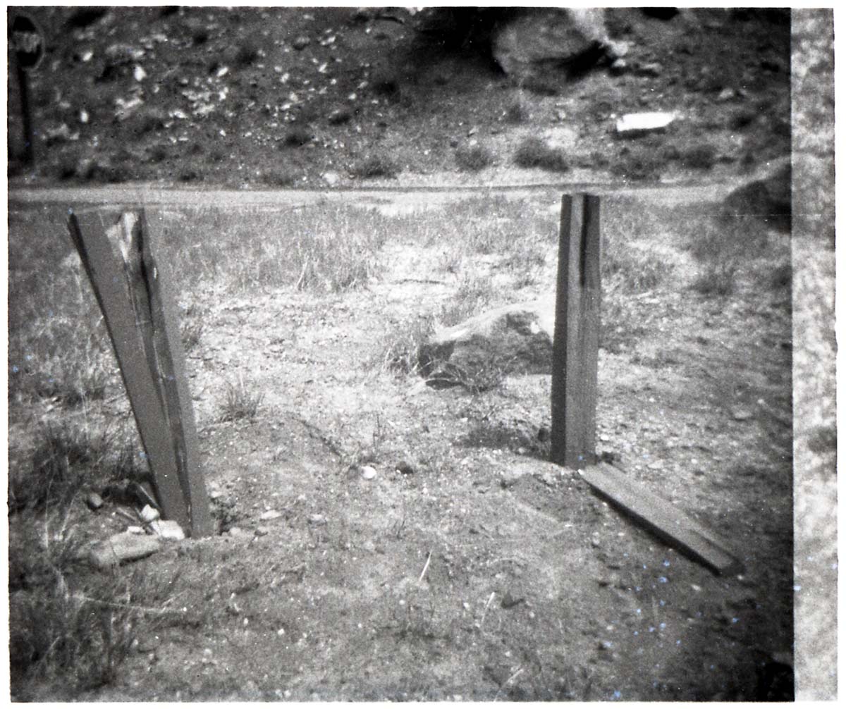 BW Photo of a rock slide along Route 2 - 110mm. Sign damage.