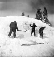 BW Photos showing rangers digging out the visitor center from snowdrift.
