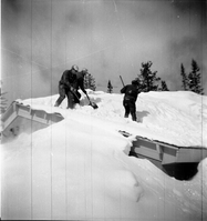 BW Photos showing rangers digging out the visitor center from snowdrift.
