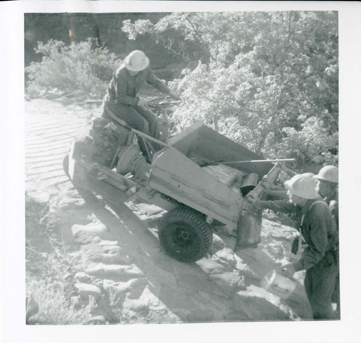 Workers operating construction equipment during the West Rim trail half tunnel maintenance/stabilization.