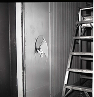 Damage to men's dorm at Zion Lodge. Large hole in door.