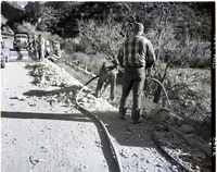 Removing old bridge curb by cutting and blasting.