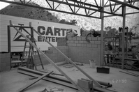 Workers building brick wall during the construction of the headquarters addition.