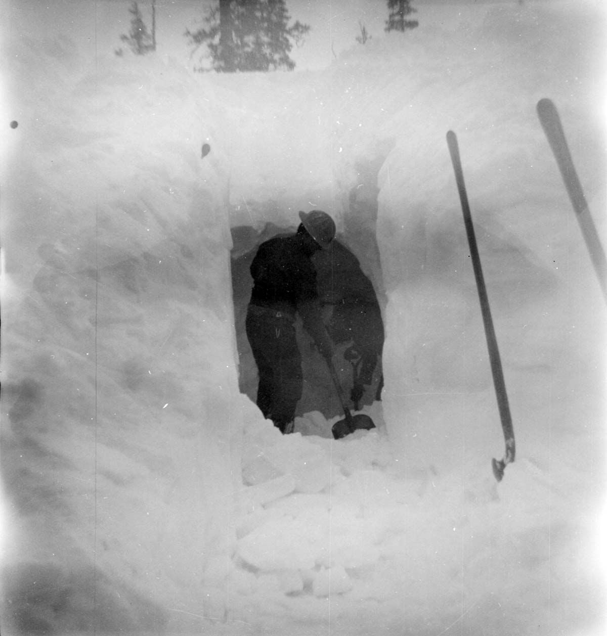 BW Photos showing rangers digging out the visitor center from snowdrift.