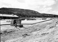 Crowds gathered for the dedication ceremony of new Tribal and National Park Service Visitor Center and celebration of the 50th anniversary of Pipe Spring National Monument. Looking at celebration from roadway.