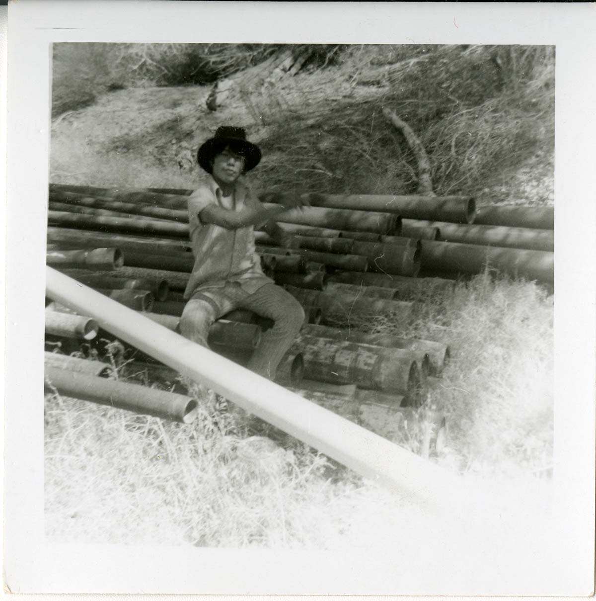Navajo worker sitting during the utility project at Watchman housing.