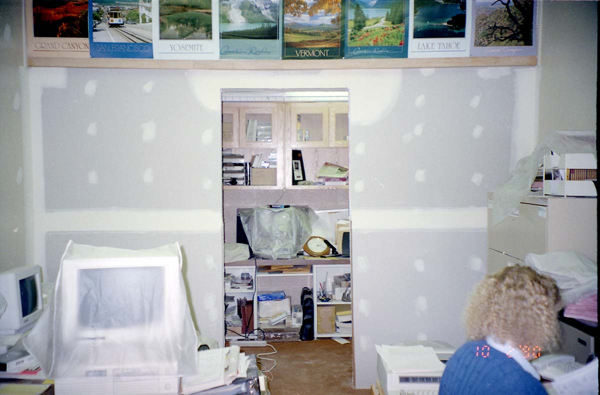 Construction of headquarters addition Image of woman working at desk during the construction of headquarters addition.