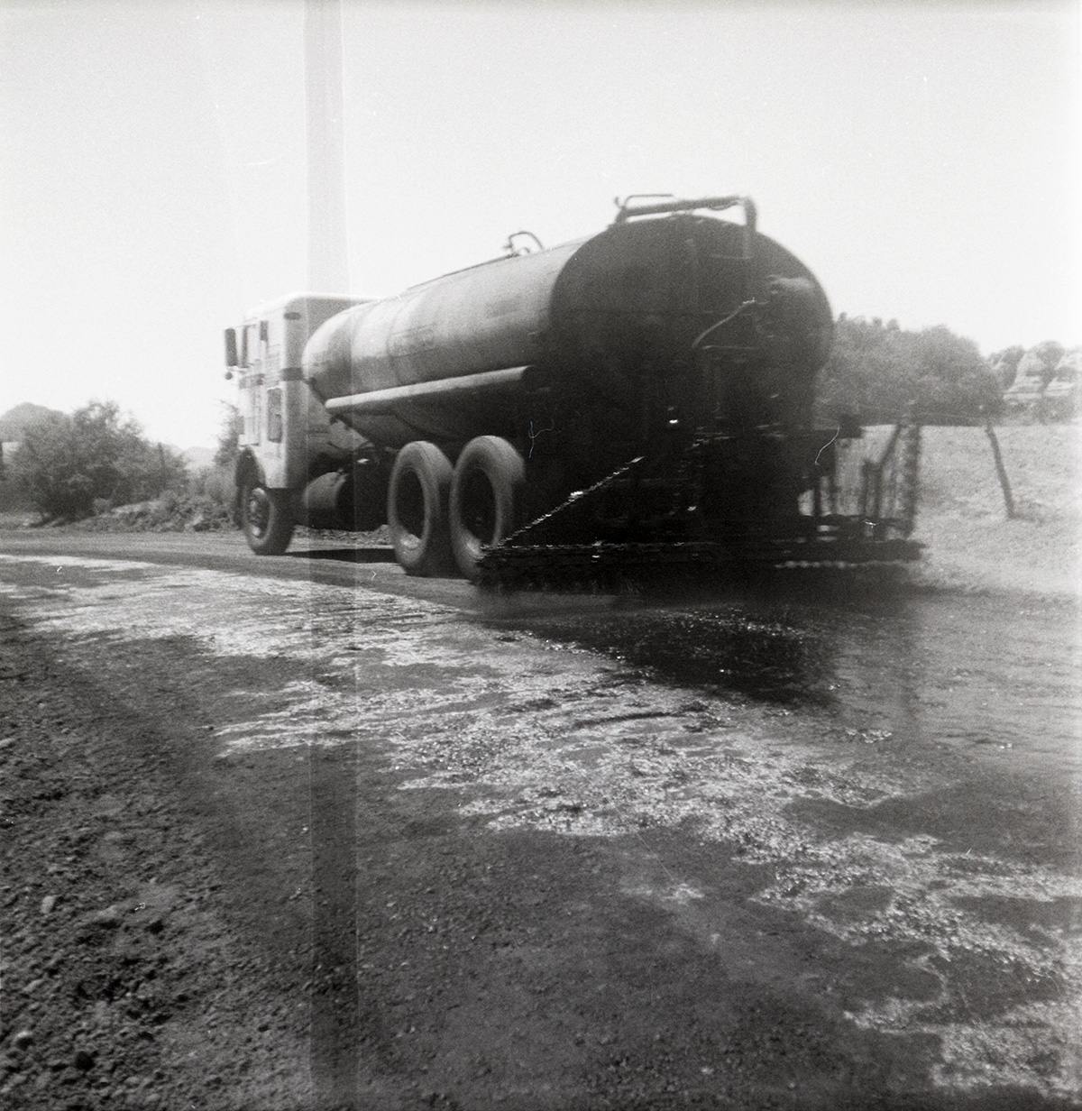 View from behind of construction vehicle during chipsealing of Kolob Canyon Road.