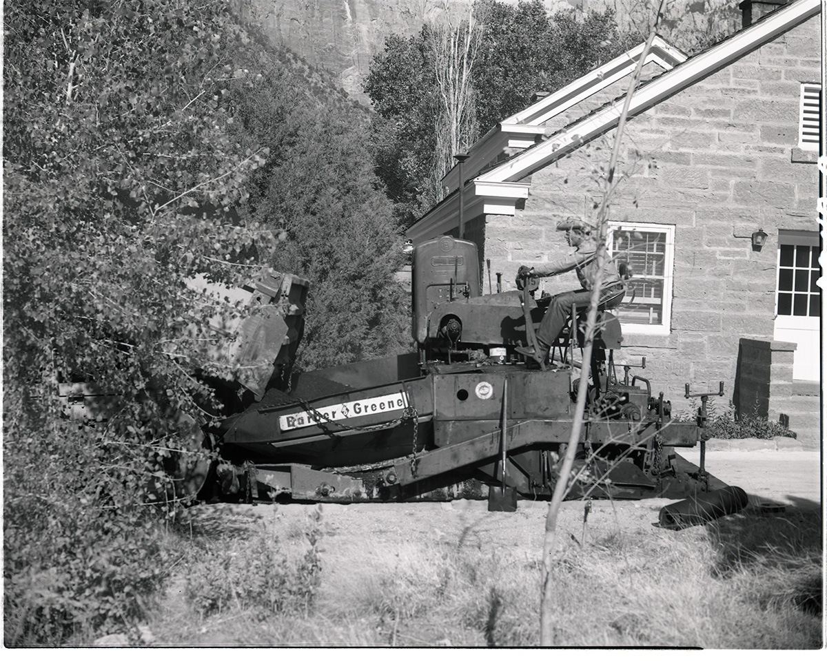 Road repair - near ranger dorm. Paving machinery at work laying hot mix.