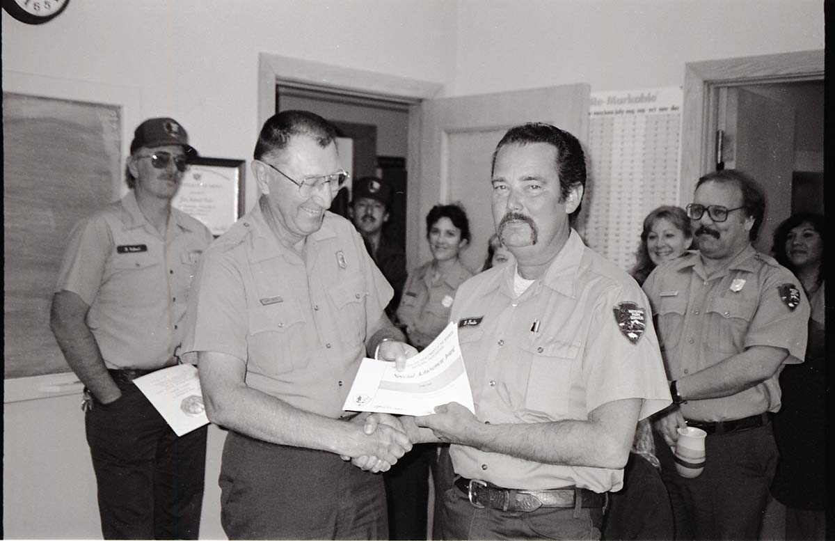 BW Photos of Superintendent Harold Grafe giving out awards to park personnel.