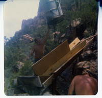 Workers loading tramline with equipment for transportation for construction of Wiley thank.