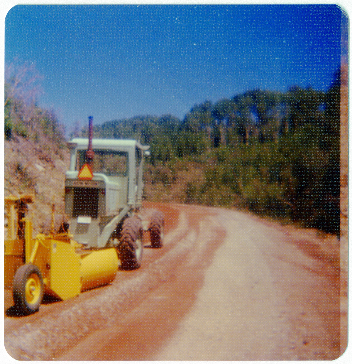 Construction vehicle performing road work along the Kolob Terrace Road.