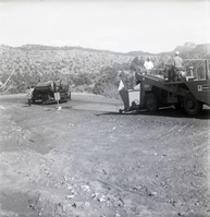 Men operating construction vehicle during chipsealing of Kolob Canyon Road.