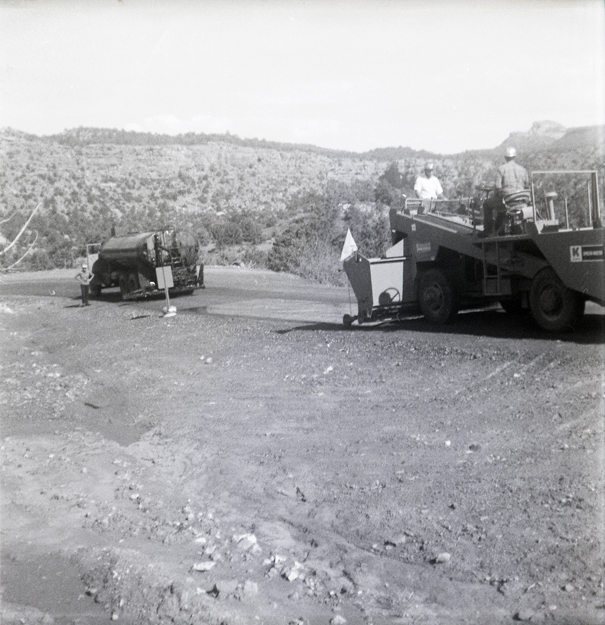 Men operating construction vehicle during chipsealing of Kolob Canyon Road.