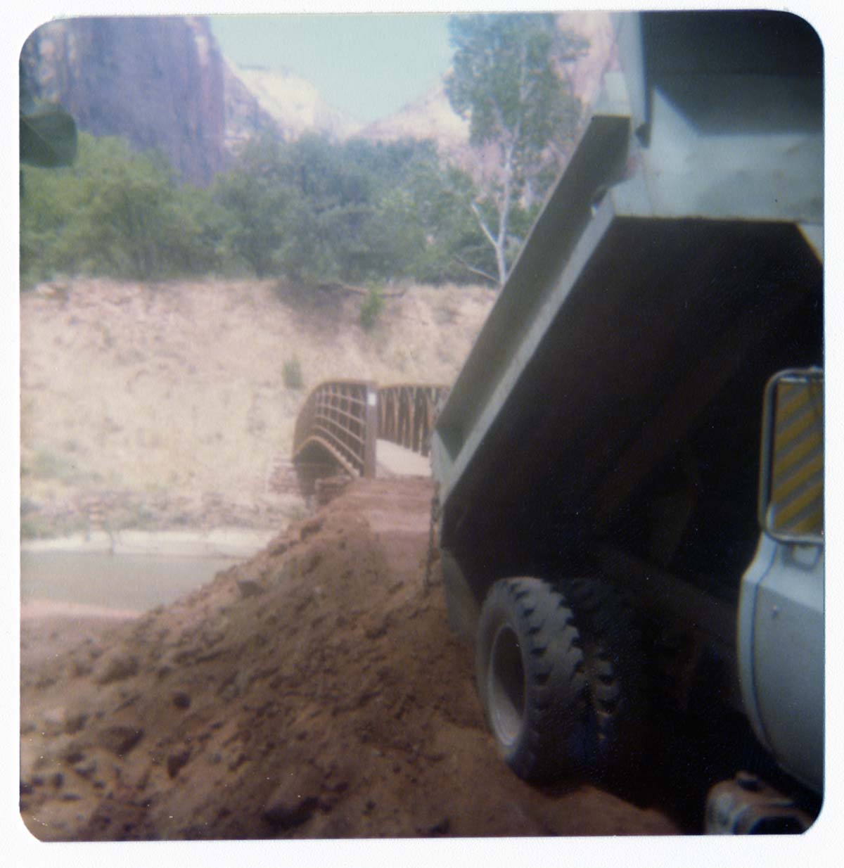 Dump truck during the arrival and emplacement of the new Zion Lodge footbridge.