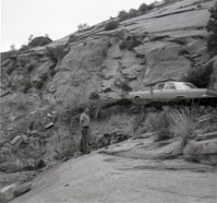 Car parked on road and man surveying area during East side road repair and turn our construction - Road projects 5104 and 5105.