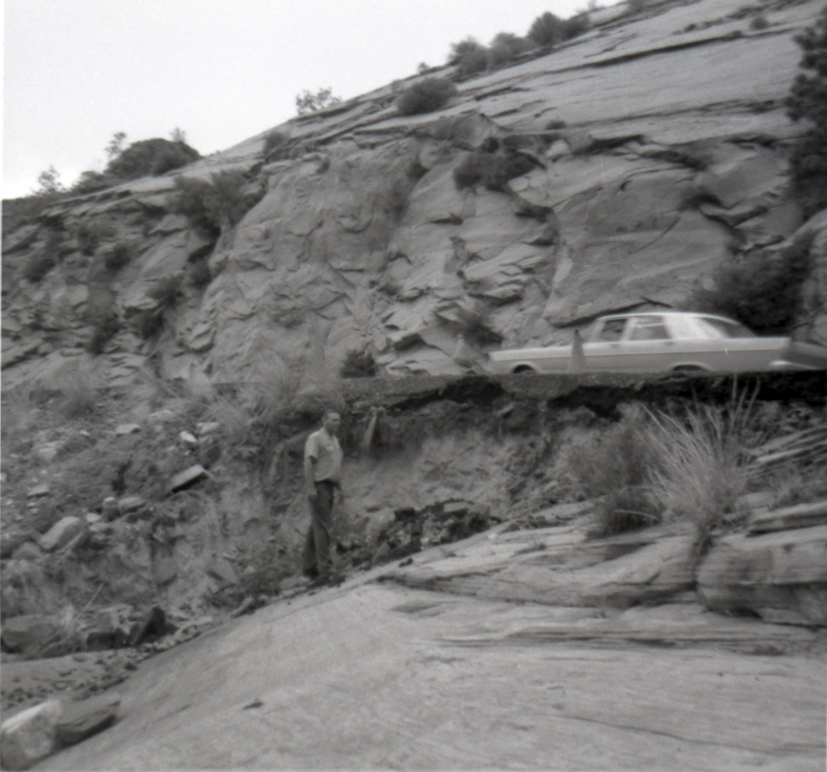 Car parked on road and man surveying area during East side road repair and turn our construction - Road projects 5104 and 5105.