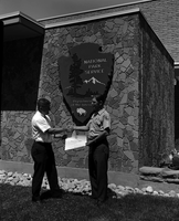 Tom Ela presents Superintendent Warren F. Hamilton with Safety Award, Second Place service-wide, in front of Mission 66 Visitor Center and Museum.